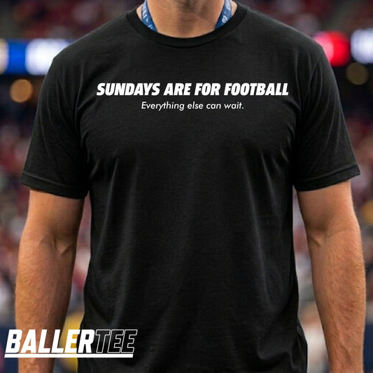 A man wearing a black short-sleeve t-shirt with the white printed text 'SUNDAYS ARE FOR FOOTBALL' and 'Everything else can wait.' The background is a blurred stadium setting.
