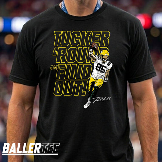 A man wearing a black graphic t-shirt with a yellow and white print that reads 'TUCKER 'ROUND AND FIND OUT!' alongside a photo of quarterback Tucker Kraft in a green and yellow uniform. The brand logo 'BALLERTEE' is visible in the bottom-left corner.