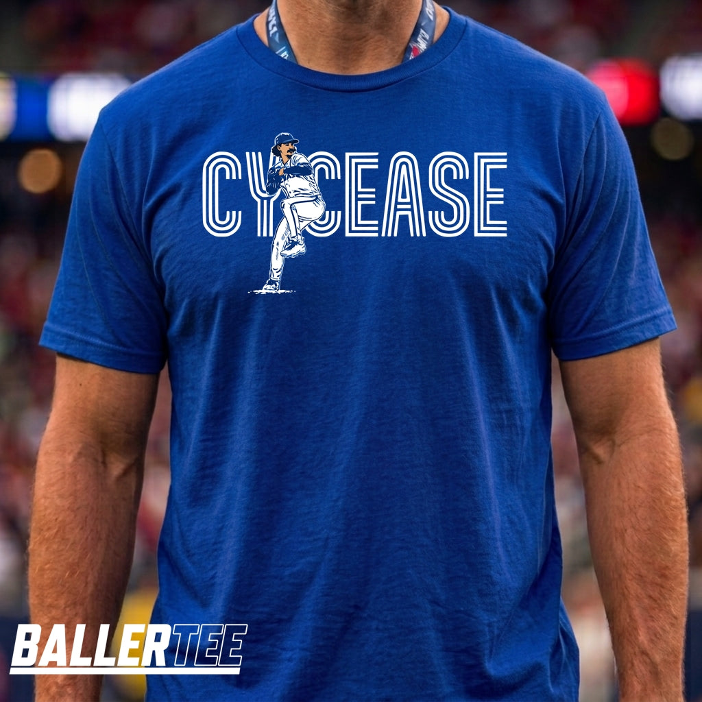 A man wearing a royal blue t-shirt with a white graphic that reads 'CYCEASE' and features a football player illustration. The brand 'BALLERTEE' is visible as a watermark in the bottom-left corner.