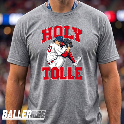 A man wearing a heather gray t-shirt with a graphic of a baseball player and the text 'HOLY TOLLE' in red. The brand 'BALLERTEE' is visible as an overlay in the bottom-left corner.