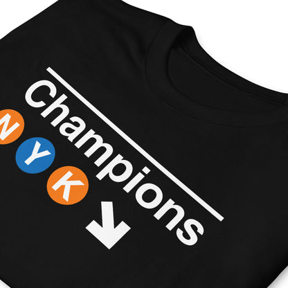 New York basketball 2026 Champions t-shirt in black – NYC subway-inspired graphic with NYK lettering in orange and blue circles by BallerTee
